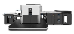 A large printer is shown with the machine in front of it.